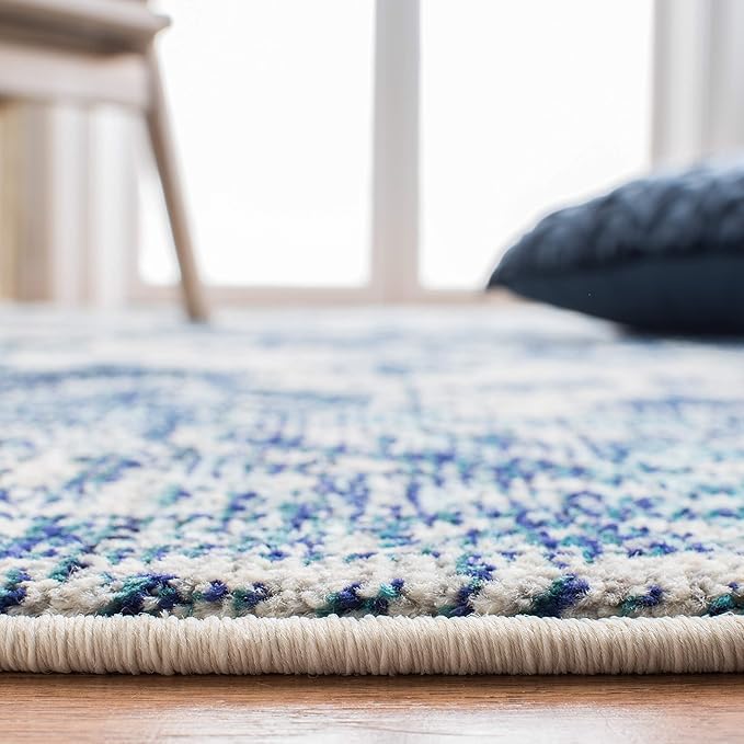 SAFAVIEH Monaco Collection Area Rug - 6'7" x 9'2", Ivory & Blue, Boho Chic Medallion Distressed Design, Non-Shedding & Easy Care, Ideal for High Traffic Areas in Living Room, Bedroom (MNC243A)